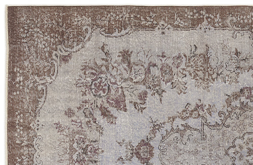 Load image 1 in gallery view. Distressed brown and light grey rug with a traditional floral medallion pattern and ornate border.
