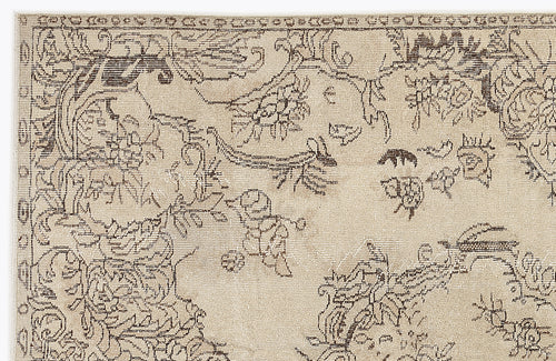 Load image 1 in gallery view. Beige rug with a dark brown distressed floral and vine pattern and a decorative border.