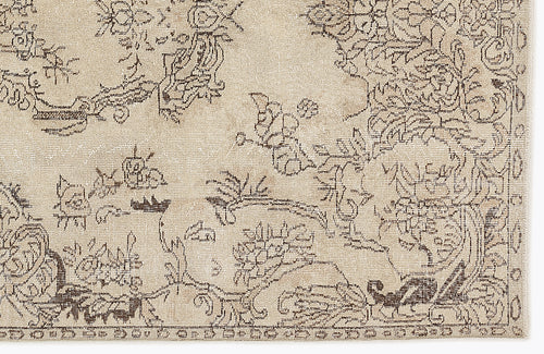 Load image 1 in gallery view. Beige rug with a dark brown distressed floral and vine pattern.