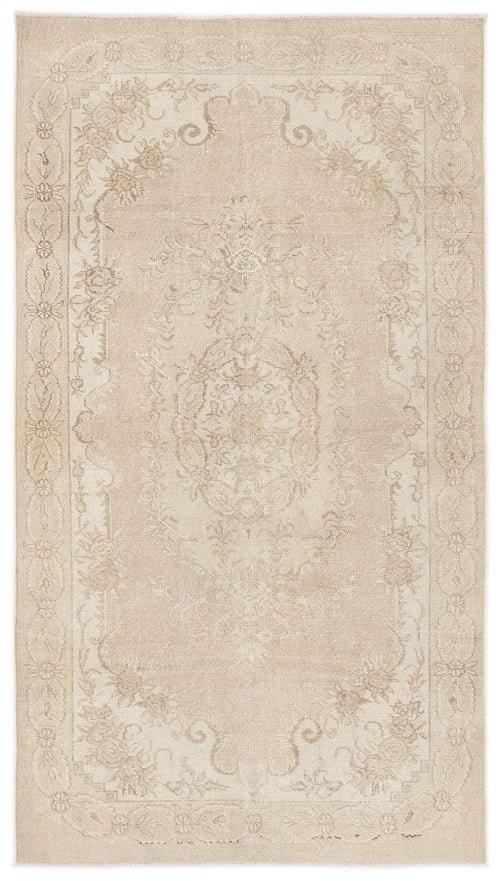 Load image 1 in gallery view. Beige area rug with a faded traditional floral medallion pattern and a decorative border.