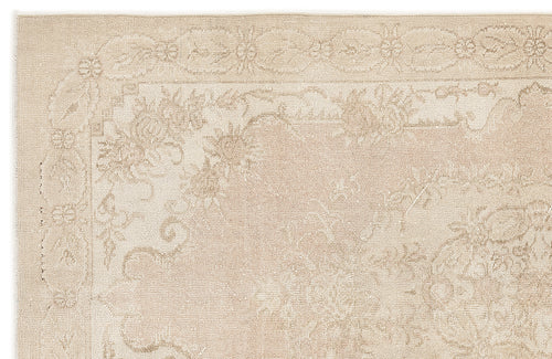 Load image 1 in gallery view. Beige monochromatic rug with a traditional floral border and central medallion pattern on a white background.
