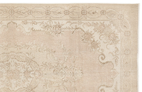 Load image 1 in gallery view. Beige and cream traditional rug with a distressed floral medallion pattern and a decorative border.