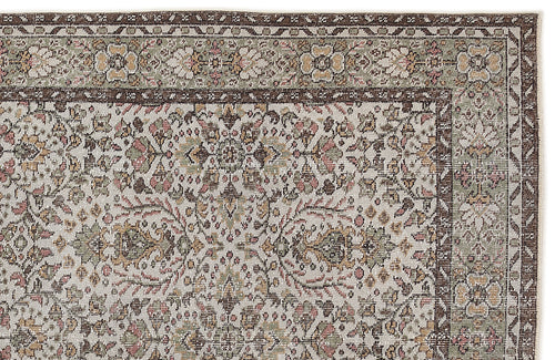 Load image 1 in gallery view. Traditional Persian-style rug with a floral medallion pattern in muted brown, sage green, and pink on a cream background.