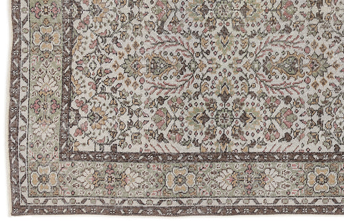 Load image 1 in gallery view. Distressed traditional rug with a floral medallion pattern in muted sage, pink, and brown on a cream background.