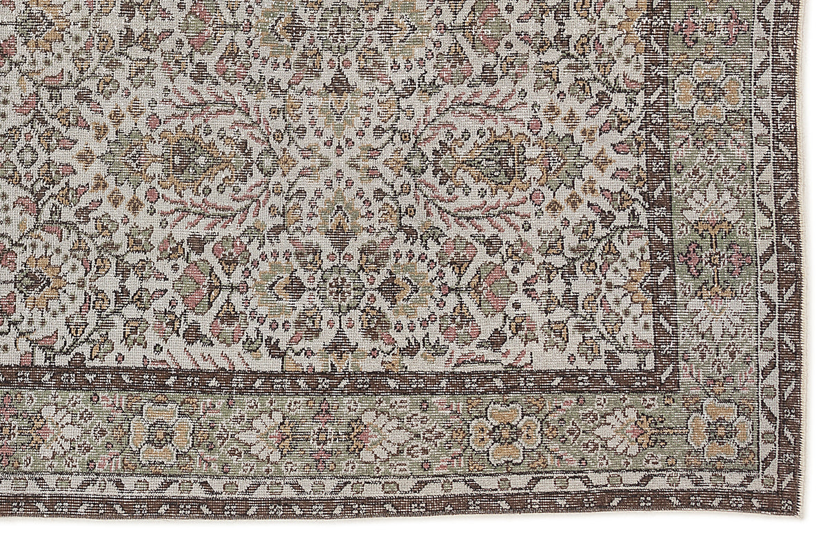 Traditional Persian-style rug with a cream field, floral medallion pattern, and a dark brown border in muted earth tones.