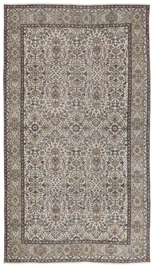 Load image 1 in gallery view. Traditional beige, brown, and sage green rug with a distressed floral medallion pattern and a wide decorative border.