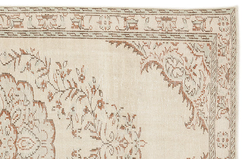 Load image 1 in gallery view. Cream and terracotta rug with a distressed floral medallion pattern and a detailed border.