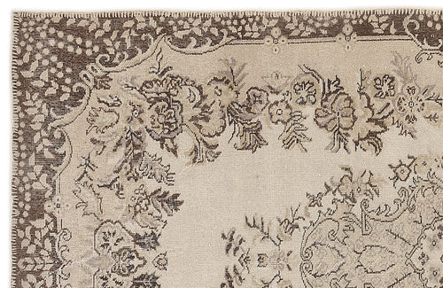 Load image 1 in gallery view. Beige and dark brown rug with a distressed floral medallion pattern and a decorative border.