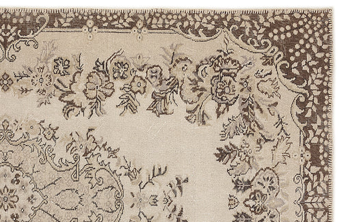 Load image 1 in gallery view. Beige and brown traditional rug with a distressed floral medallion pattern and a stitched border.