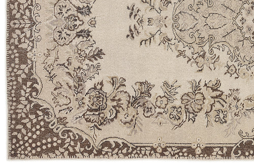 Load image 1 in gallery view. Beige and dark brown rug with a distressed traditional floral medallion pattern.