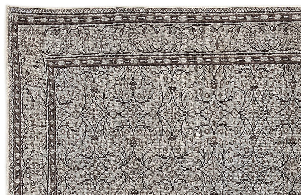 Grey and brown rug with a traditional floral lattice pattern and a detailed geometric border.