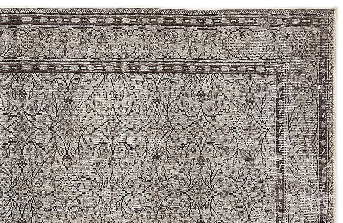 Taupe and charcoal grey rug with a traditional floral medallion pattern and a detailed border.