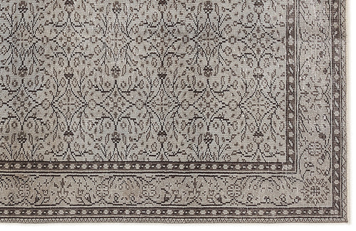 Load image 1 in gallery view. Taupe and charcoal rug with a traditional distressed floral pattern and a detailed geometric border.