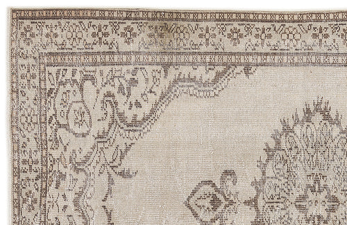 Load image 1 in gallery view. Beige and brown vintage-style rug with a distressed floral medallion pattern and a decorative border.