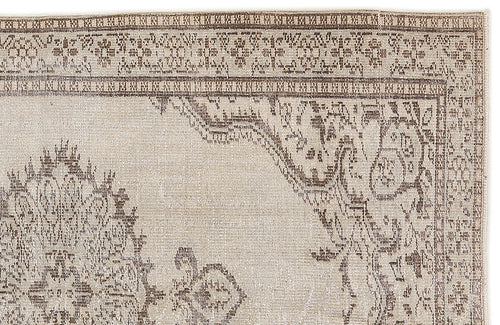 Load image 1 in gallery view. Beige and brown rug with a distressed traditional medallion pattern and a detailed geometric border.