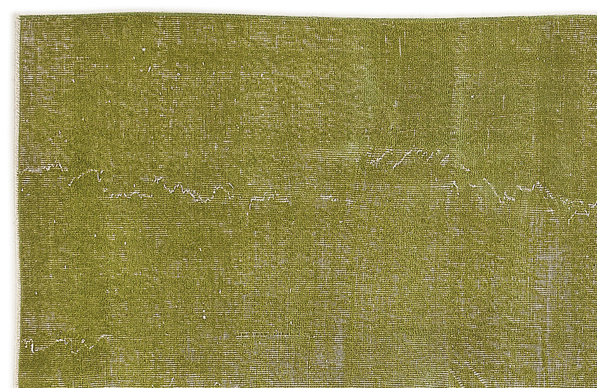 Olive green distressed rug with a subtle, faded white linear pattern on a white background.