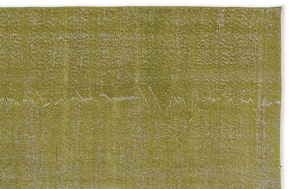 Olive green rug with a distressed, textured finish and subtle white linear detailing.