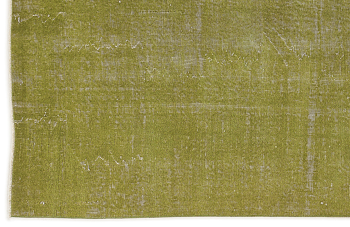 Olive green rug with a distressed, weathered texture and visible white woven base.