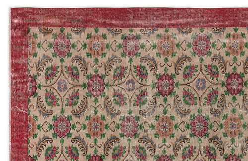 Load image 1 in gallery view. Beige rug with a red border and a repeating floral medallion pattern in red, green, and blue on a white background.