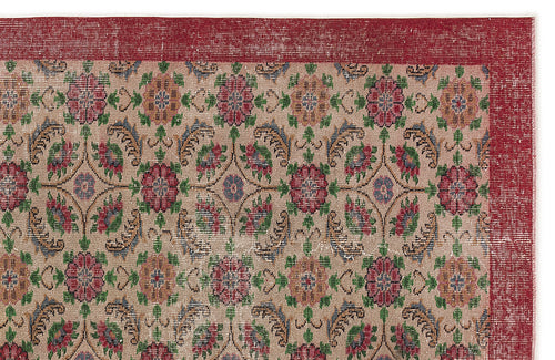 Load image 1 in gallery view. Beige rug with a red border and a repeating floral medallion pattern in red, green, and blue on a white background.