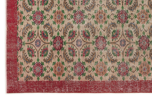 Load image 1 in gallery view. Beige rug with a repeating floral medallion pattern in red, green, and blue, featuring a wide red border.