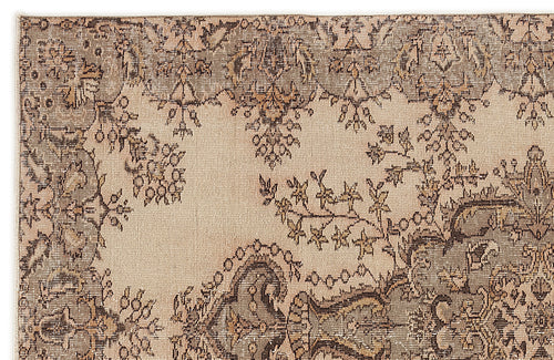 Load image 1 in gallery view. Beige and taupe rug with a distressed traditional floral medallion pattern.