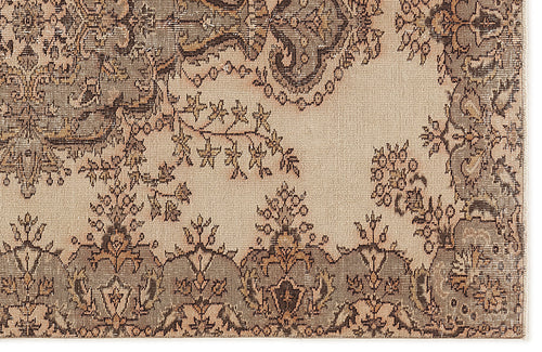 Load image 1 in gallery view. Beige rug with a distressed, dark brown and tan traditional floral medallion pattern.