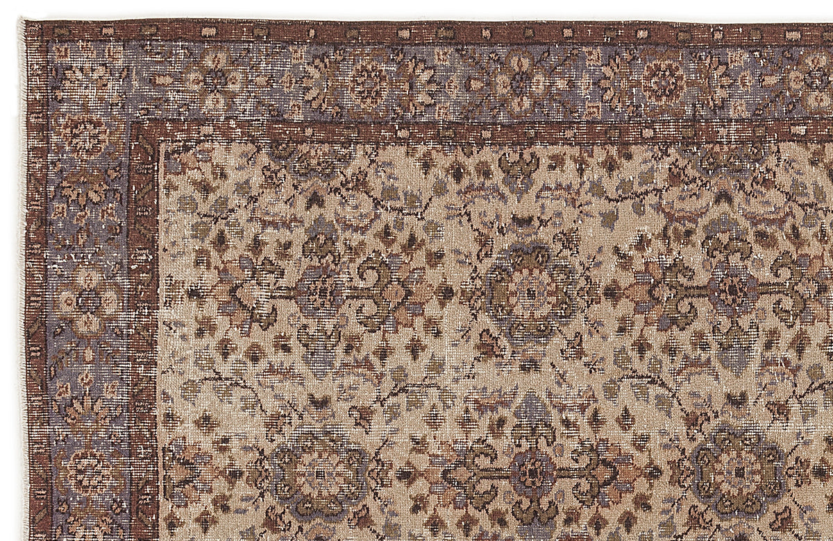 Distressed beige, brown, and slate blue rug with a traditional floral medallion pattern and a wide decorative border.