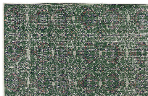 Load image 1 in gallery view. Dark green rug with a repeating circular medallion pattern in distressed white, blue, and pink tones.