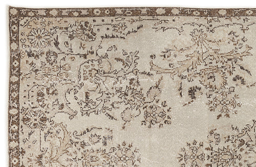 Load image 1 in gallery view. Beige and brown vintage-style rug with a distressed floral medallion pattern and a decorative border.