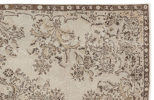 Load image 1 in gallery view. Beige and brown vintage-style rug with a distressed floral medallion pattern and a decorative border.