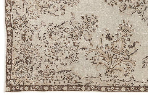 Load image 1 in gallery view. Beige and brown distressed rug with a faded floral medallion pattern and a decorative border.