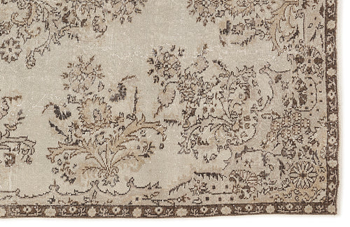 Load image 1 in gallery view. Beige and brown distressed rug with a traditional floral pattern and a decorative border.