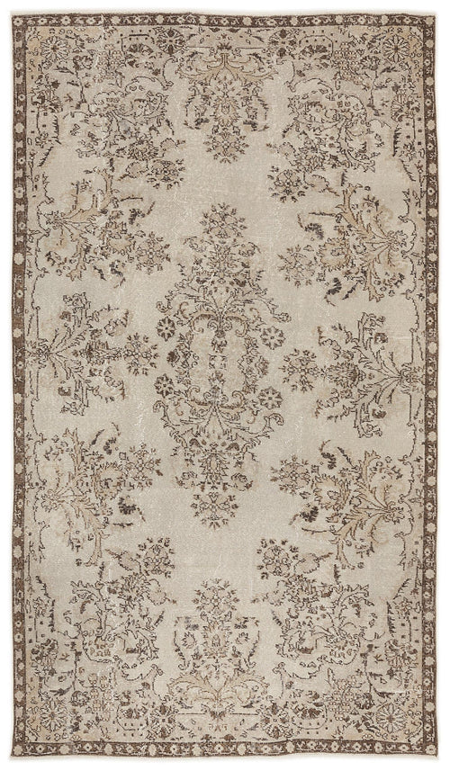 Load image 1 in gallery view. Beige and brown distressed rug with a central floral medallion and ornate border pattern.