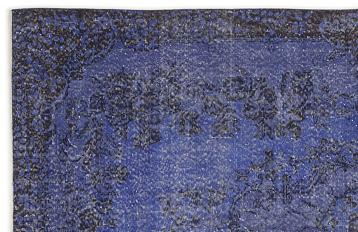 Navy and royal blue distressed rug with a traditional floral medallion pattern.