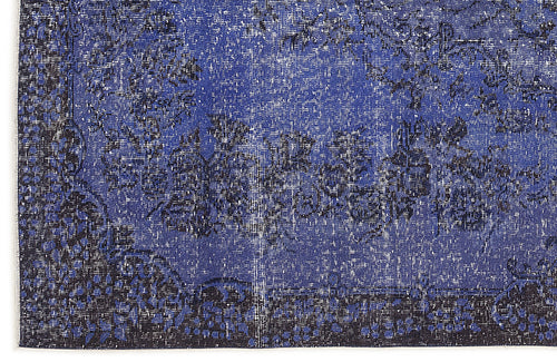 Load image 1 in gallery view. Deep blue and black distressed rug with a faded traditional floral medallion pattern.