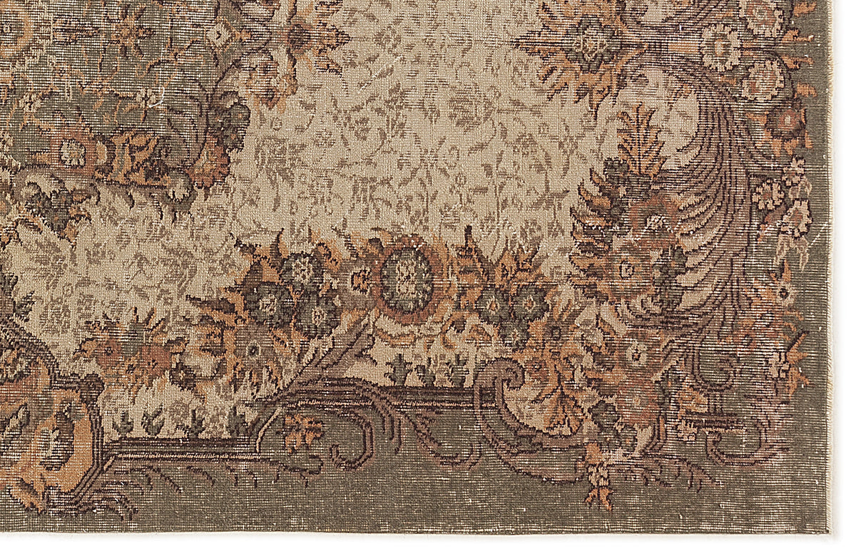 Distressed olive green and terracotta floral medallion rug with a traditional ornate border.