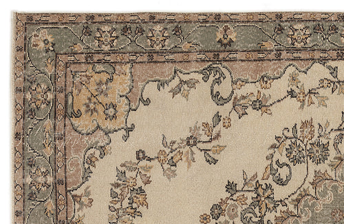 Load image 1 in gallery view. Beige rug with a sage green and brown floral border and central vine motif in a traditional style.