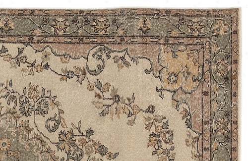 Load image 1 in gallery view. Beige, sage green, and tan traditional rug with a distressed floral medallion pattern on a white background.