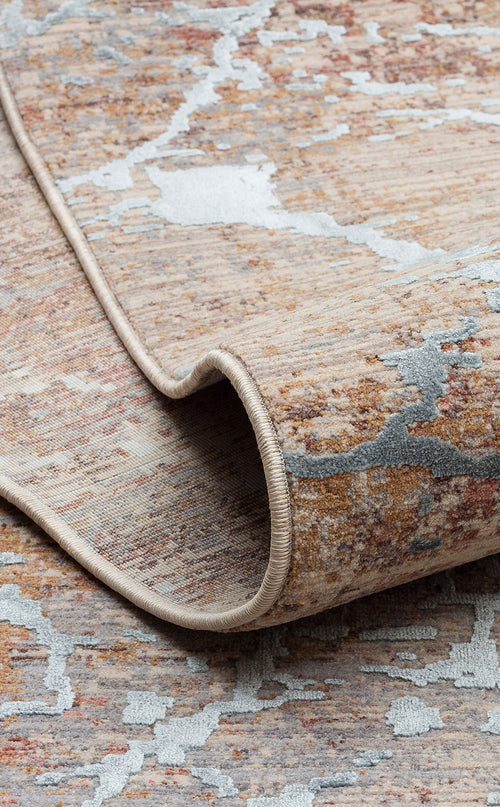Load image 1 in gallery view. Beige, rust, and light blue abstract distressed rug with a rolled corner showing a finished edge.