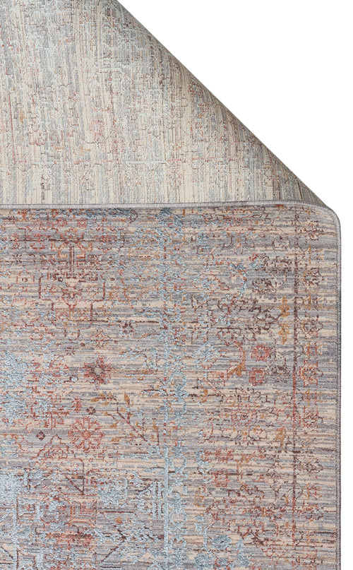 Load image 1 in gallery view. Distressed grey, blue, and rust-colored traditional rug with a faded floral medallion pattern, shown with a corner folded.