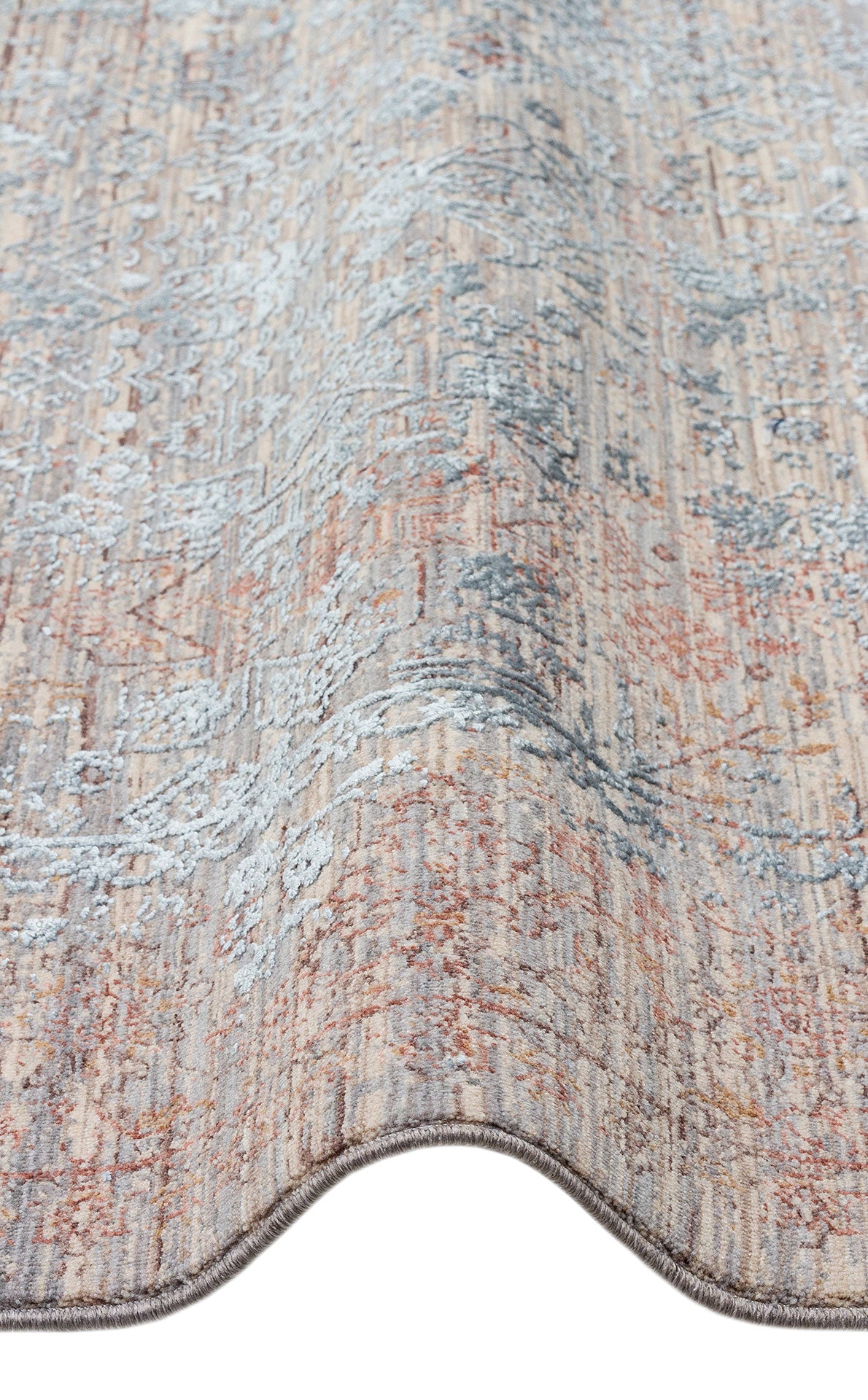 Beige, rust, and slate blue transitional rug with a distressed, faded floral pattern on a white background.