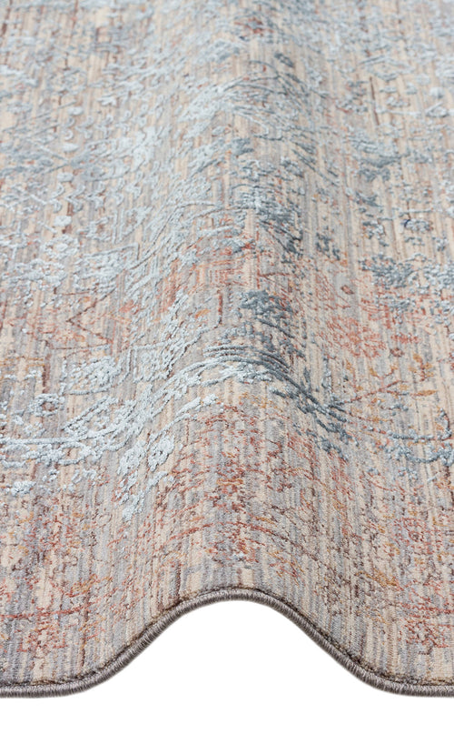 Load image 1 in gallery view. Beige, rust, and slate blue transitional rug with a distressed, faded floral pattern on a white background.