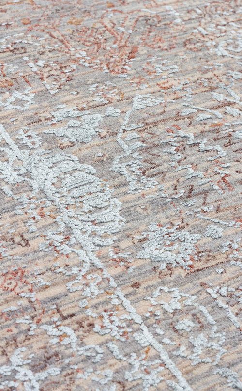 Load image 1 in gallery view. Distressed rug with a raised light blue floral pattern over a textured beige, grey, and rust-colored base.