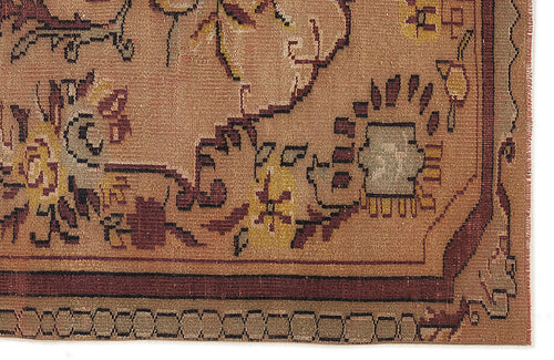 Load image 1 in gallery view. Brown traditional rug with a geometric border and stylized floral motifs in mustard, maroon, and grey.