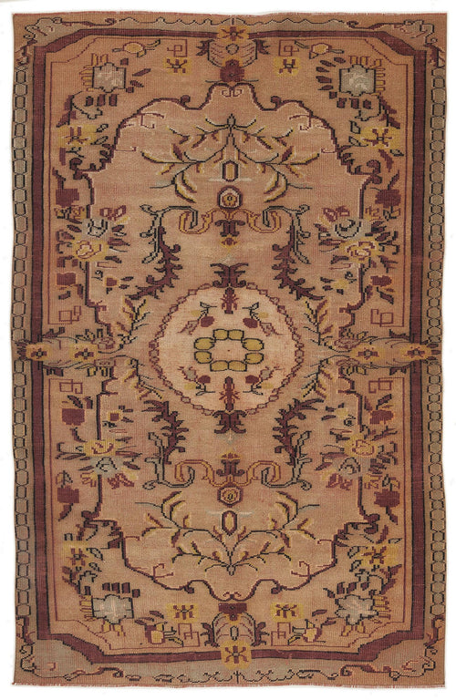 Load image 1 in gallery view. Tan and rust-colored traditional rug with a central floral medallion and geometric border on a white background.