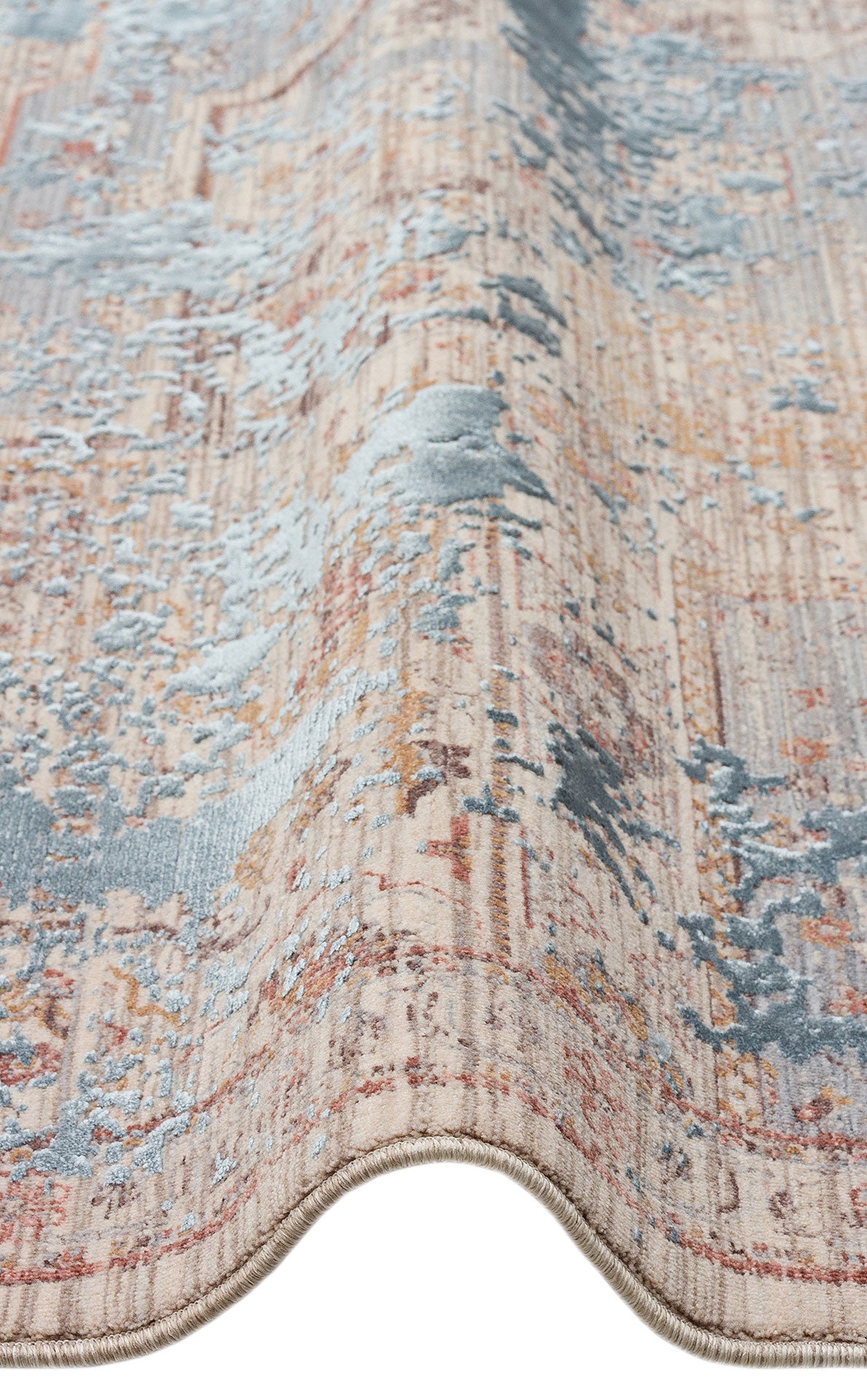 Beige, blue, and rust-colored rug with a distressed, abstract medallion pattern and a serged edge.