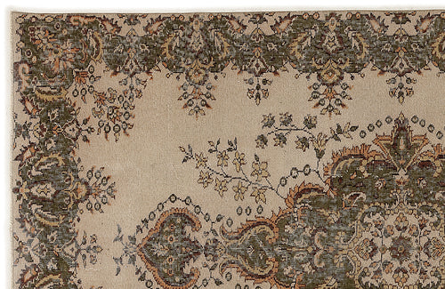 Load image 1 in gallery view. Beige rug with a dark green and rust-colored traditional floral medallion pattern and a wide decorative border.