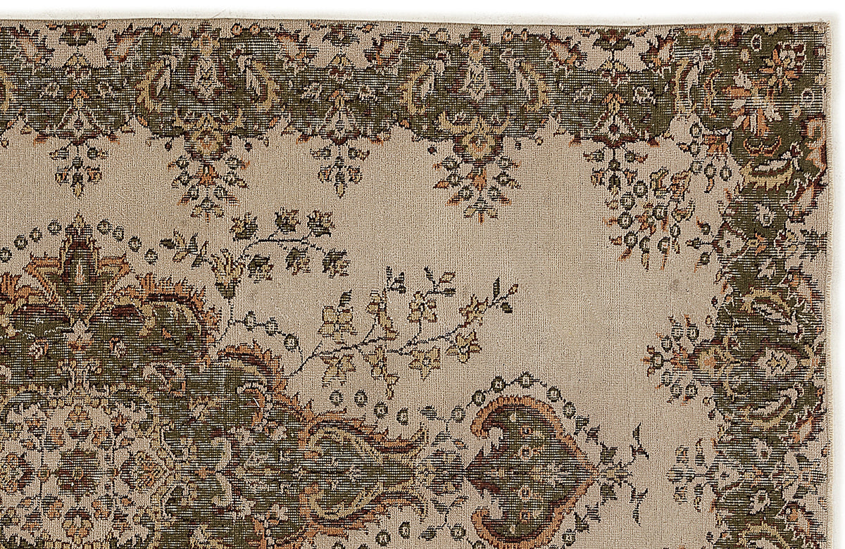 Beige rug with a dark green and rust-colored traditional floral border and central medallion pattern.