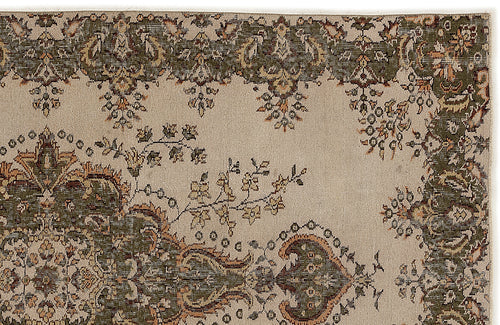 Load image 1 in gallery view. Beige rug with a dark green and rust-colored traditional floral border and central medallion pattern.
